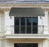 A gray awning is installed above a balcony with a glass door and a metal railing. Anteprima dell’immagine prodotto