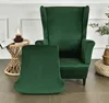 A green velvet wingback chair and ottoman are shown in a room setting. Anteprima dell’immagine prodotto