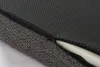 Close-up view of a dark gray orthopedic seat cushion with a zipper partially open, revealing white foam padding. Produktbild-Vorschau