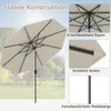A collage of images showcasing a beige hexagonal patio umbrella, highlighting its construction and features, with a blurred outdoor background. Náhled obrázku produktu