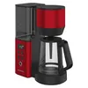 A red and black filter coffee maker with a glass carafe and a digital display. Náhled obrázku produktu