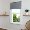 A roller blind is shown partially covering a window in a room, with shelves on either side. Produktbild-Vorschau