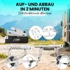 A camping table and its parts are shown in a mountainous outdoor setting, with a caravan in the background. Produktbild-Vorschau