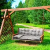 A wooden swing bench with gray cushions is set up in a grassy garden with trees and a path in the background. Náhled obrázku produktu