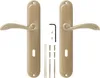 A pair of bronze door handles with their accompanying hardware, laid out against a white background. Produktbild-Vorschau
