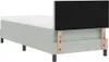 A light gray box spring bed with a mattress and a black headboard attached by wooden supports. Produktbild-Vorschau