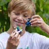 A young boy is holding two small toy cars. Produktbild-Vorschau