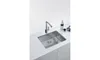 A stainless steel kitchen sink with a modern faucet is shown on a white countertop. Náhled obrázku produktu