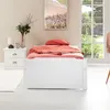 A white bed with coral bedding and a pillow in a bedroom setting. Produktbild-Vorschau