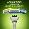 A close-up shot of razor blade refills and a razor handle against a green gradient background. Náhľad obrázku produktu