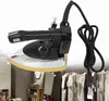 A professional studio shot of an industrial steam iron against a white background, with a blurred background showing a clothing rack and interior. Podgląd zdjęcia produktu