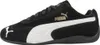 A side view of a black Puma sneaker with white accents and gold branding. Voir les images du produit