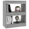 A gray wooden bookshelf with books and decorative items on it. Voir les images du produit