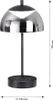 A black and silver modern table lamp with a dome-shaped shade. Produktbild-Vorschau