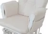 Close-up of a cream-colored upholstered rocking chair with a white frame. Anteprima dell’immagine prodotto