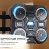A close-up of a black and gray smart music boxing machine with blue LED lights, mounted on a wall. Produktbild-Vorschau