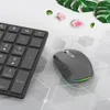 A black wireless mouse and keyboard are placed on a white surface with decorative leaves and flowers. Náhled obrázku produktu