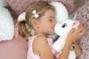 A young girl sleeping and hugging a plush unicorn. Podgląd zdjęcia produktu