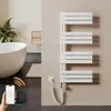 A modern bathroom with a freestanding bathtub, a plant, and a white electric towel warmer. Produktbild-Vorschau