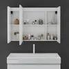 A white medicine cabinet with doors open, displaying various bathroom products, above a white sink with a chrome faucet. Voir les images du produit
