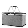 A gray foldable picnic basket with a white handle and black zipper, shown against a white background. Produktbild-Vorschau