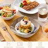A table setting with a salad, steak, dessert, and a drink, suggesting a meal. Náhled obrázku produktu