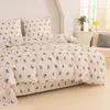 A bed with floral patterned bedding. Produktbild-Vorschau
