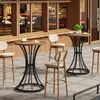 An outdoor seating area of a cafe with tables and chairs. Produktbild-Vorschau