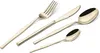 A set of four champagne-colored cutlery pieces with black accents, arranged diagonally on a white background. Anteprima dell’immagine prodotto