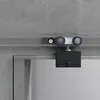 A close-up view of a sliding glass door mechanism, showing the rollers and mounting hardware against a textured gray wall. Produktbild-Vorschau