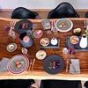 A beautifully set dining table with multiple place settings, food, and floral arrangements. Podgląd zdjęcia produktu
