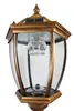 A close-up view of a classic-style solar garden lantern with a gold-colored frame and clear glass panels. Produktbild-Vorschau