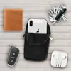 A flat lay of everyday carry items including a wallet, smartphone in a pouch, Swiss Army knife, car keys, and earphones, arranged on a wooden surface. Produktbild-Vorschau