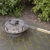 A sandwich maker is being used on a grill over hot coals in an outdoor setting. Anteprima dell’immagine prodotto
