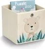 A beige storage cube with a cartoon bear illustration on the front, containing a puzzle box. Voir les images du produit