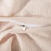 A close-up view of a beige fabric with a zipper. Podgląd zdjęcia produktu