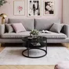 A living room scene with a sofa, coffee table, and artwork. Produktbild-Vorschau