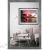 A living room scene with a pink sofa, a coffee table, a floor lamp, and a framed picture of a sunset over the ocean. Produktbild-Vorschau