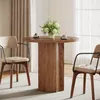 A round dining table with two chairs in a well-lit room with curtains. Produktbild-Vorschau
