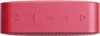 A close-up view of the top surface of a red portable speaker, showing control buttons. Produktbild-Vorschau
