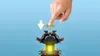 A hand is shown pressing down on a LEGO toy. Produktbild-Vorschau