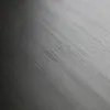 A close-up, angled view of a dark, textured surface, likely wood grain, with a gradient of light to dark. Produktbild-Vorschau
