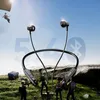 A scene depicting a battle royale game scenario with a parachute, characters, and a supply drop, featuring a pair of black neckband headphones. Anteprima dell’immagine prodotto
