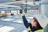 A construction worker using a Bosch power tool on a construction site. Produktbild-Vorschau
