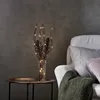 A decorative vase with LED lights sits on a side table next to a sofa. Podgląd zdjęcia produktu