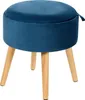 A blue velvet ottoman with wooden legs is shown against a white background.