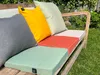 Cushions on a wooden bench in a garden setting. Anteprima dell’immagine prodotto