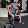 A man is performing bicep curls with dumbbells in a gym. Náhled obrázku produktu