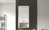A white wall-mounted bathroom cabinet with a shelf at the bottom, set against a dark gray wall. Produktbild-Vorschau
