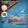 A flat lay of an art set, with the case open and art supplies spread out, including a drawing of a sunset. Náhled obrázku produktu